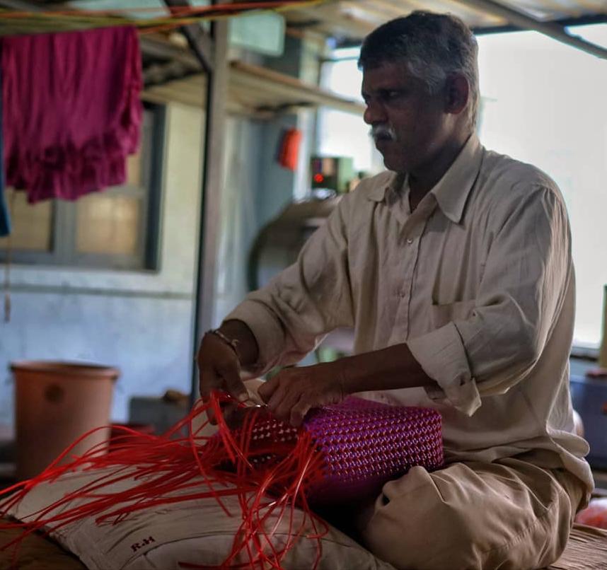 A resident making cane baskets as part of an OT session