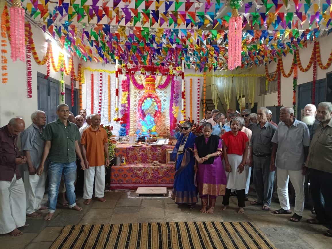 A group of residents with the statue of God Ganesha on the occasion of Ganesh Utsav