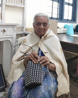 A picture of Mrs. Tata during the interview, as she weaves a cane basket