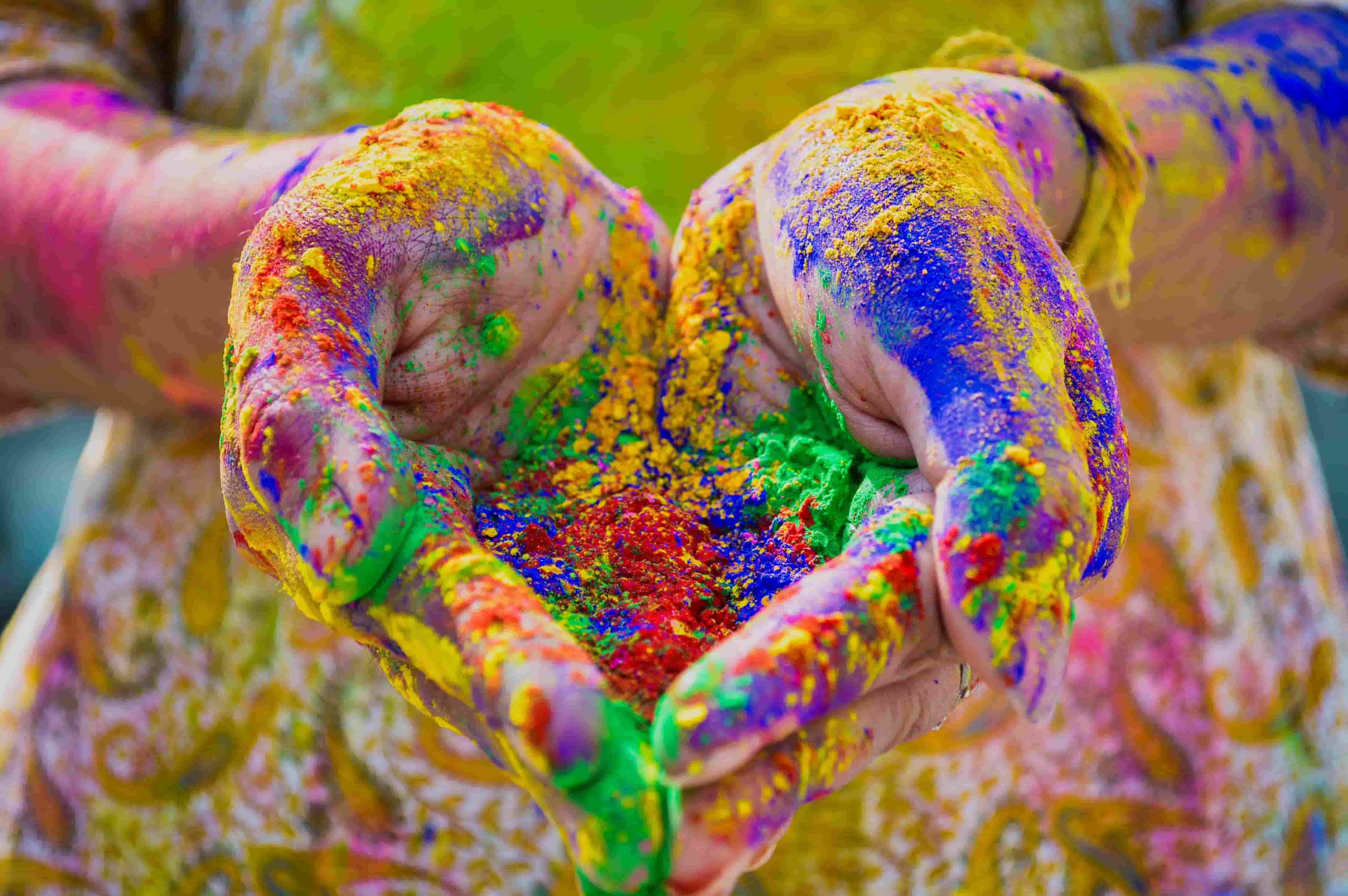 A person's hands full of colours usually thrown at the festival of Holi